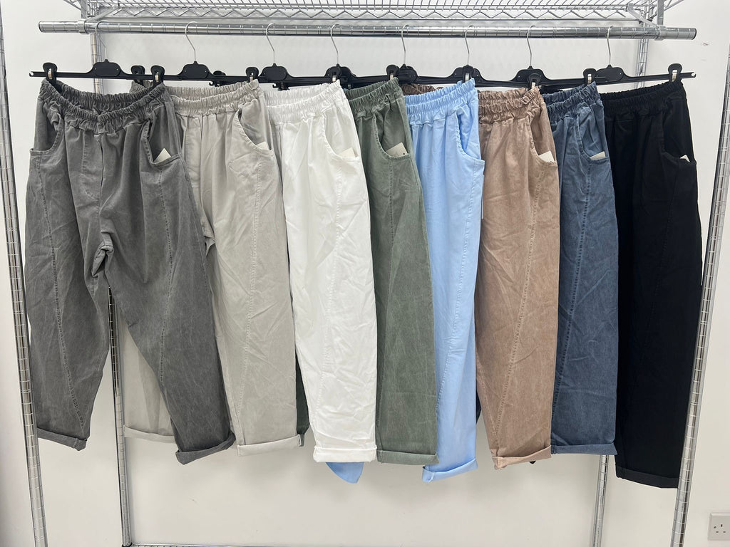 rail of acid wash relaxed magic trousers in charcoal, stone, white, khaki, light denim, fawn, dark denim and black