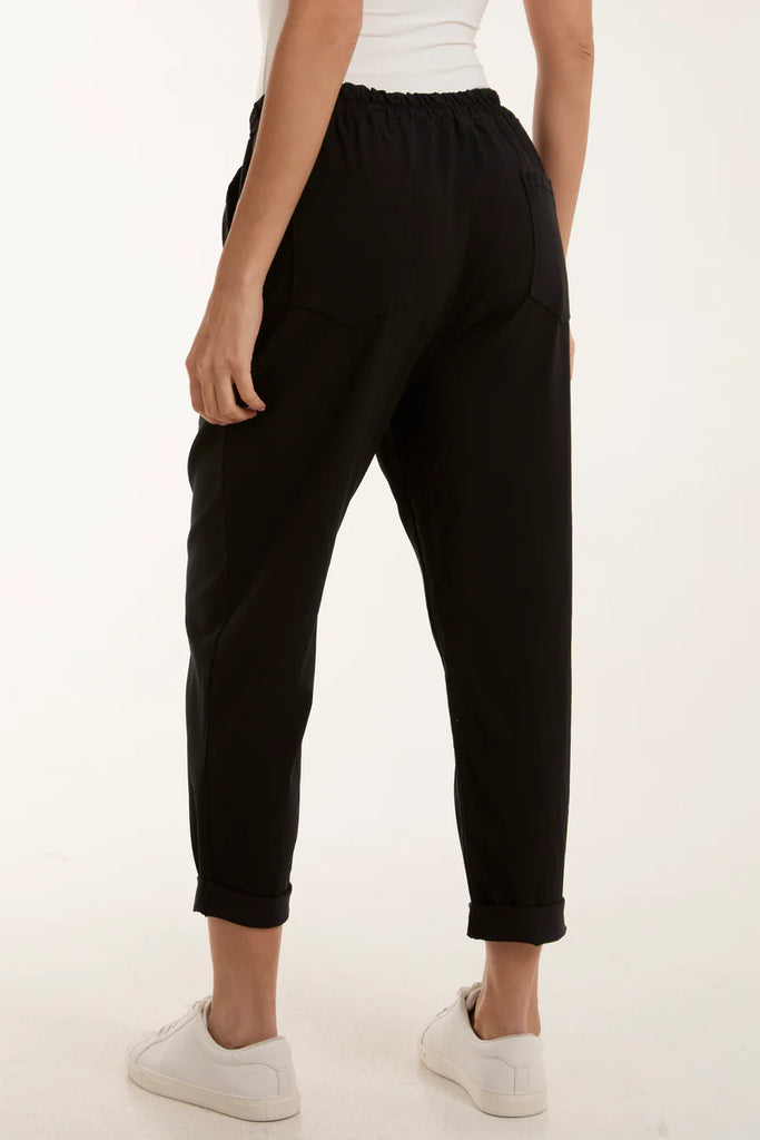 black relaxed magic trousers side view