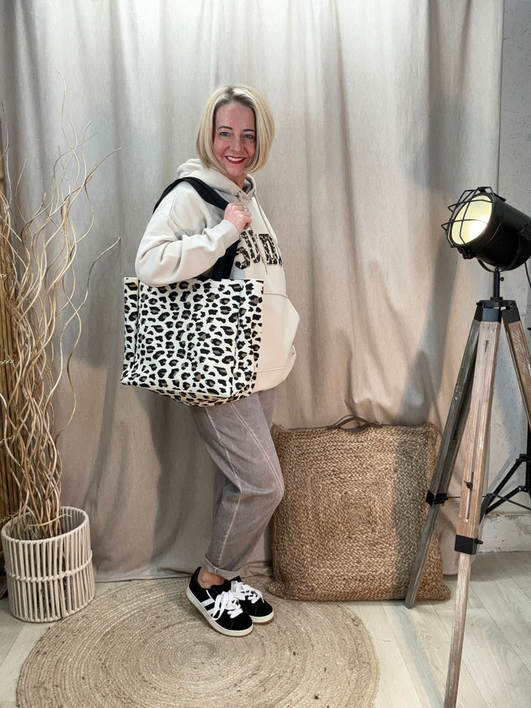 fawn acid wash relaxed magic trousers worn with a beige hoodie and leopard print bag