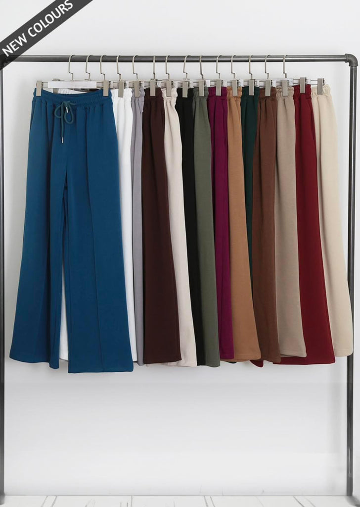 rail of luxe wide leg seam front joggers in teal, white, mocha, black, khaki, green, burgundy and beie