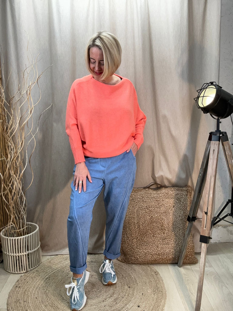 light denim relaxed magic trousers with a coral slash neck knit batwing top